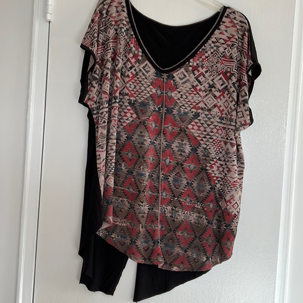 96% rayon 4% spandex v-neck top with divided back tail. Size L.